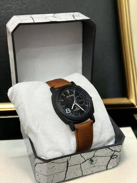Wristwatch with brown leather strap in a decorative box