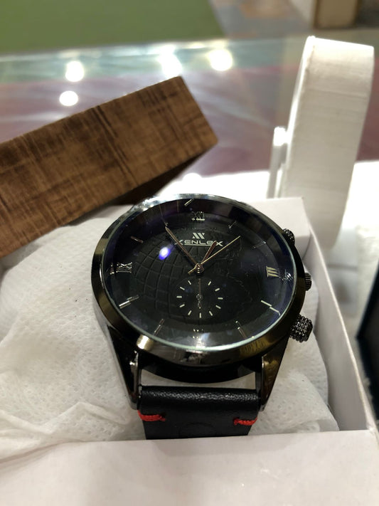 Black wristwatch with a detailed face in a box